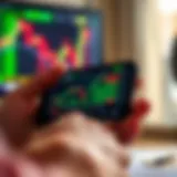 Mobile phone displaying IQ Option trading platform interface with market charts